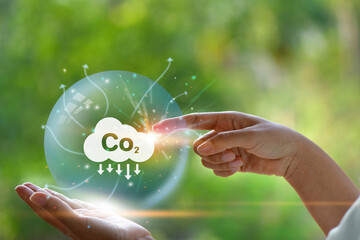 CO2 emission reduction concept in hand with environmental icons,. Energy saving, Sustainable...