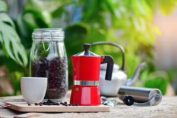 Moka pots, coffee maker with coffee cup and coffee beans on wooden table,