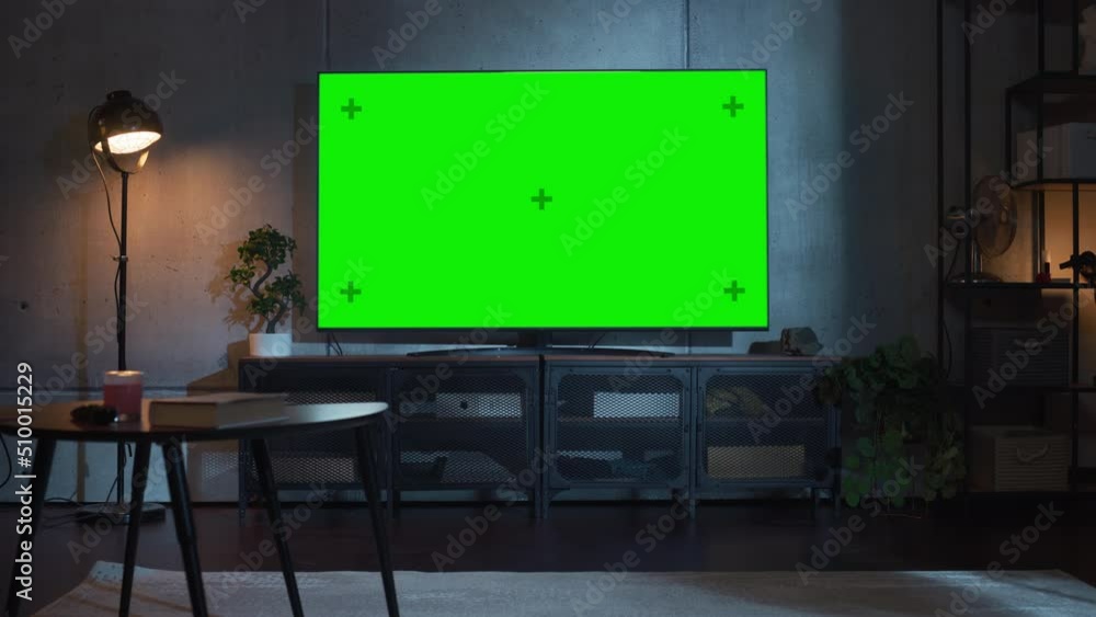 Poster stylish loft apartment interior with tv set with green screen mock up display standing on television