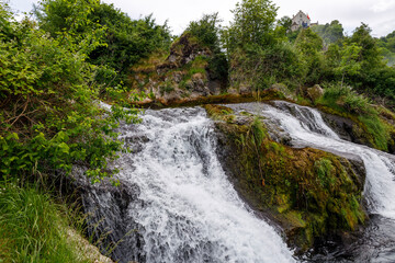 Fototapeta na wymiar Small waterfall. Ferns