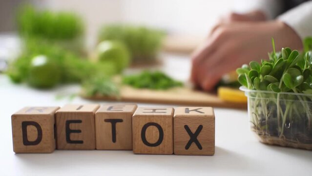Green vegetables, fruits, herbs. Deoxidation. Weight loss, detoxification, healthy eating. Preparation of green smoothies. Сoncept of diet, proper nutrition, health. Woman's hands cutting ingredients