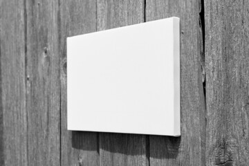 White stretched canvas mockup on wooden wall