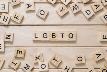 Abbreviation LGBTQ with letter blocks on wooden background