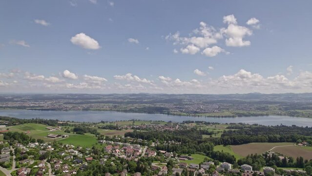 Aerial view over Lake Greifensee Canton Z&uuml;rich, with scenic rural landscape on a blue cloudy summer day. Movie shot June 10th, 2022, Forch, Switzerland.