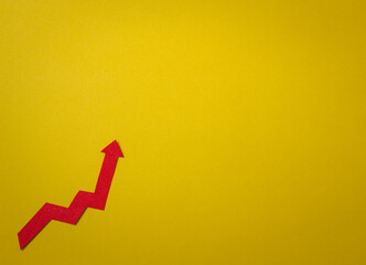 Red arrow on the yellow background. Financial investment and risk concept.