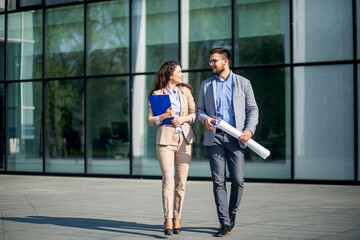 Business colleague discussing while walking