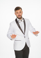 a kind man in a white jacket with a bow tie poses with positive emotions. cheerful man in the studio on a white background isolated shows a range of positive emotions