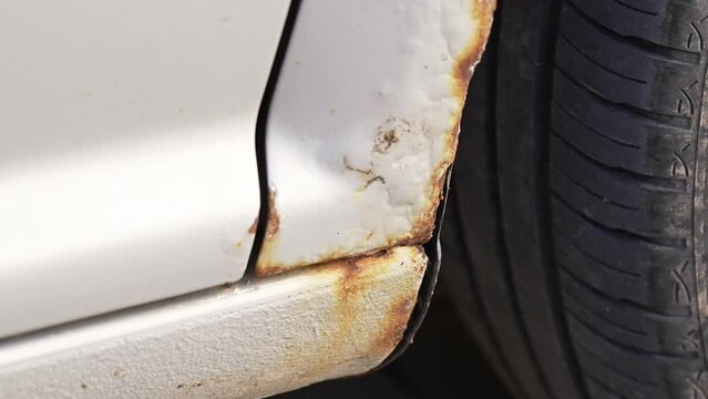 Fragment of a car body with rust