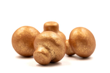 Mushroom chocolate isolated on white background. Close-up. Mushroom-shaped coated chocolate dragee