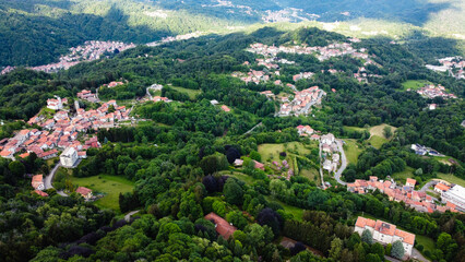 Aerial view of The Alpine foothills in Piedmont region, northwestern Italy. Green hills in the Italian Alps. - obrazy, fototapety, plakaty