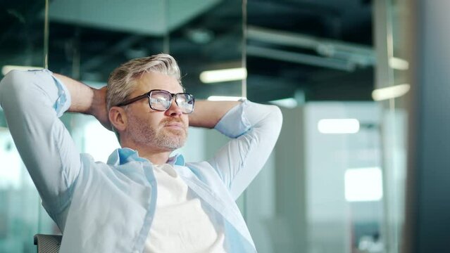 Mature Employee job done Satisfied office worker leaning back businessman relaxing after hard working day finished project on computer stretching at workplace happy ceo eyes closed taking pause