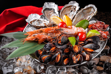 large plate with fresh open ready to eat oysters on a plate with ice shrimp mussels 