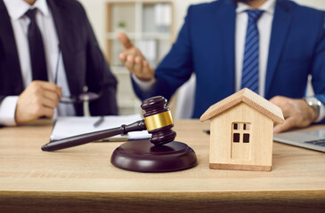 Lawyer and client make agreement of house mortgage during negotiations in office. Home model and...
