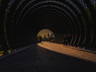 Reflection of the sun inside the wooden tunnel in Park Gorkogo Moscow Russia 08.05.2022