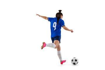 Dynamic portrait of female professional soccer, football player practicing isolated on white studio...