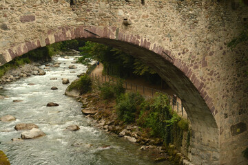 Old stone bridge over the river Passer in Meran, South Tirol, Italy