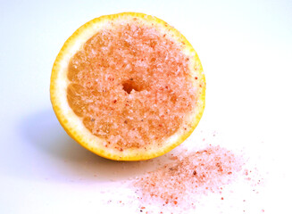 Half a lemon in pink salt