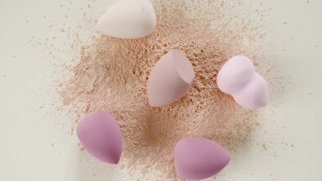 Make-up sponges, makeup brush on beige background. Powder, Particles of Cosmetics on the Table. Makeup products. The beauty of the background. Makeup, the concept of skin care with. High quality 4k