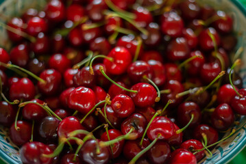 Ripe dark red cherries heaped on a platter