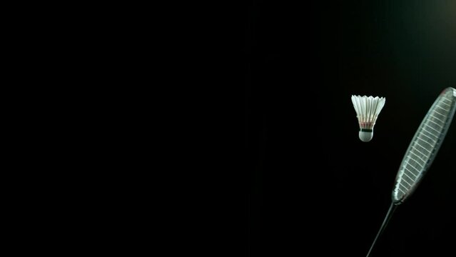 Super Slow Motion Shot of Hitting Badminton Shuttlecock with Neon Powder by Racket at 1000fps.
