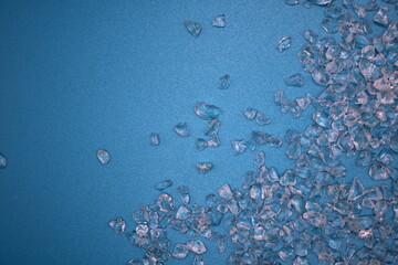 Crushed glass on a blue background with an area for text to be added
