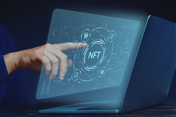 Crypto business concept NFT or non-fungible token. Selling and buying pictures. Hand person with laptop