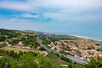 Fototapeta na wymiar Vista from Torre di Palme to the villages of Marina Palmense and Santa Maria a Mare, over the E55 highway in Marche region in Italy.
