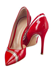 Flirtatiously standing classic red shoes made of glossy genuine leather on a high elegant heel, with a transparent insert isolated on a white background.