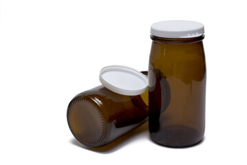 two brown milk glass bottles white background