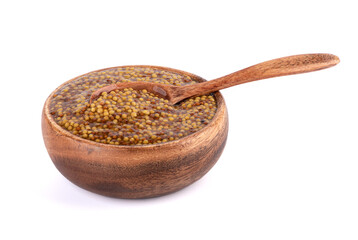 A wooden bowl full of Dijon or French mustard and a wooden spoon in it.