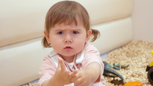 Charming Portrait Of A Toddler Showing An Upset Facial Expression. Close Up
