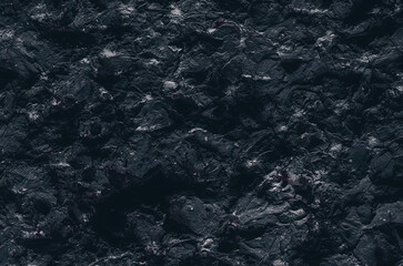 Grunge Rough structure. Black texture. Stone background. Dark marble. Rock texture. Rock surface with cracks. Rock pile. Paint spots wall. Abstract texture.