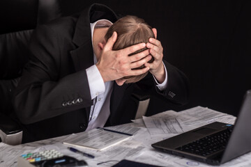 A man with receipts and invoices.Crisis, slump.Insolvent debt obligations on loans among the...