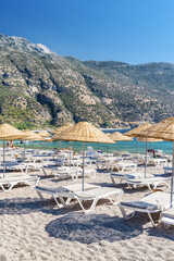 Beach umbrellas and sun loungers on Oludeniz Beach in Turkey