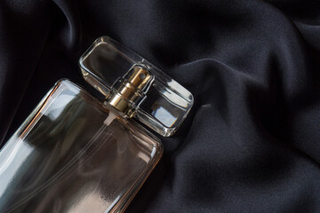 Close up of a bottle of perfume on a black background. Top view of an elegant, laconic composition...