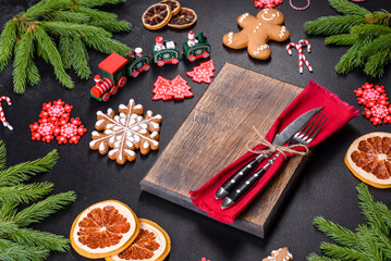 Festive Christmas table with appliances, gingerbreads, tree branches and dried citrus trees