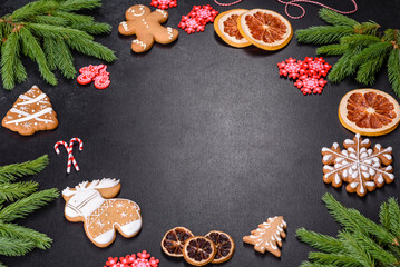 Festive Christmas table with appliances, gingerbreads, tree branches and dried citrus trees