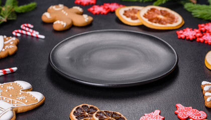 Festive Christmas table with appliances, gingerbreads, tree branches and dried citrus trees