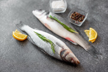 raw sea bass fish on stone background