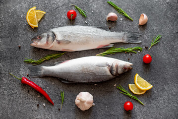 raw sea bass fish on stone background
