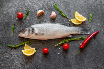 raw sea bass fish on stone background