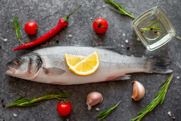 raw sea bass fish on stone background