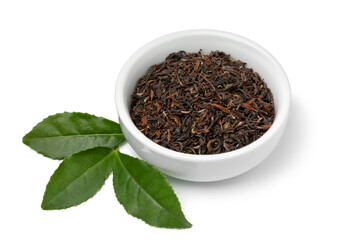 Bowl with dried Indian Ambootia Darjeeling tea leaves close up isolated on white background