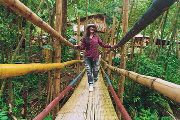 girl crossing bridge in forest