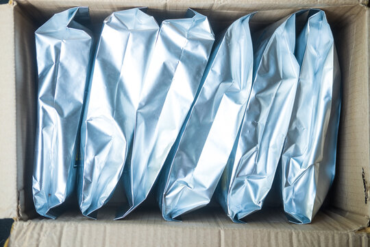 Big hermetic package for coffee beans arrange in brown box for transport