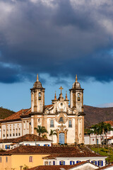 Fototapeta na wymiar Facade of imposing and old historic church in baroque style in downtown Ouro Preto, Minas Gerais, Brazil