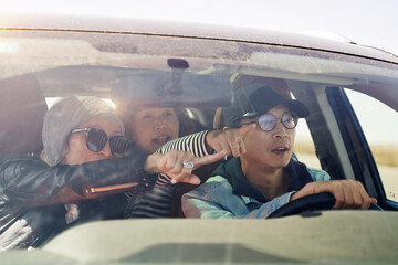 group of asian tourists traveling by car and having a good time