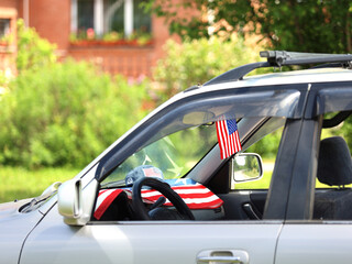 American flag on the car. Independence Day concept. USA holiday.