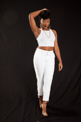 Lovely black woman in a white outfit looking pensive