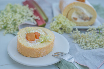 Sweet home made biscuit roll with rhubarb and elderflower on a table